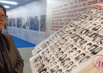 Fereshteh Akhlaghi looks on at the List of 20,000 PMOI Martyrs
